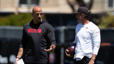 San Francisco 49ers head coach Kyle Shanahan, right, confers with defensive coordinator Robert Saleh during the team’s rookie minicamp.