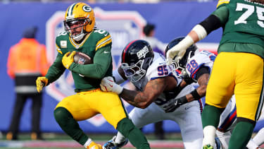 Nov 16, 2025; East Rutherford, New Jersey, USA; Green Bay Packers running back Josh Jacobs (8) runs the ball against New York Giants defensive tackle Roy Robertson-Harris (95) during the first quarter at MetLife Stadium. Mandatory Credit: Vincent Carchietta-Imagn Images