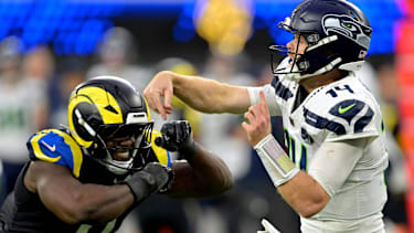 Seattle Seahawks quarterback Sam Darnold (14) is pressured by Los Angeles Rams linebacker Byron Young (0)