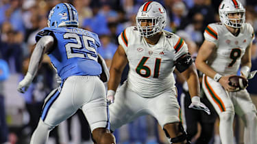 University of Miami Freshman Francis Mauigoa (61) blockt North Carolina Senior Kaimon Rucker (25) im NCAA-College-Football-Spiel zwischen der University of Miami und der University of North Carolina im Kenan Memorial Stadium in Chapel Hill, North Carolina.&nbsp;xDavidxBeachx