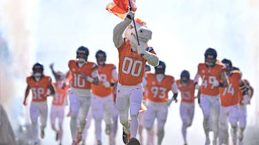 Denver Broncos mascot Miles runs accross the field ahead of players before the AFC Divisional Round game against the Buffalo Bills