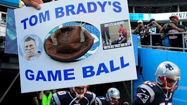 Aug. 28, 2015 - Charlotte, NC, USA - New England Patriots quarterback Tom Brady, right, runs past Larry Smith s sign on Friday, Aug. 28, 2015, at Bank of America Stadium in Charlotte, N.C., prior to preseason action. Smith is from Newland, N.C. New England at Carolina - ZUMAm67_