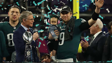 Philadelphia Eagles quarterback Nick Foles (9) holds his son and waves during the victory celebration after Super Bowl LII