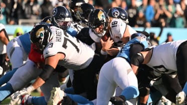 Nov 30, 2025; Nashville, Tennessee, USA; Jacksonville Jaguars quarterback Trevor Lawrence (16) carries the ball for a first down against the Tennessee Titans during the second half at Nissan Stadium. Mandatory Credit: Steve Roberts-Imagn Images