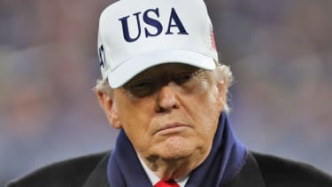 President Donald J. Trump stands on the field during the first half of the 126th