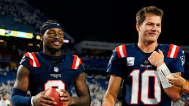 New England Patriots quarterback Drake Maye (10) and wide receiver Stefon Diggs (8) walks off the field