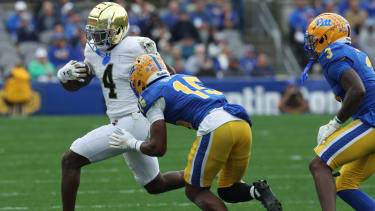 Notre Dame Fighting Irish running back Jeremiyah Love (4) runs after a catch against Pittsburgh Panthers defensive back Rashad Battle (15) and linebacker Rasheem Biles (3) during the second quarter at Acrisure Stadium. Mandatory Credit: Charles LeClaire-Imagn Images