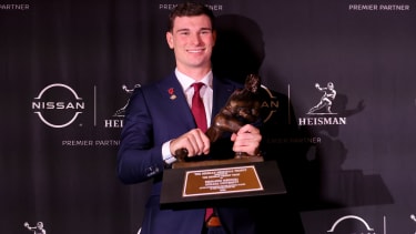 Dec 13, 2025; New York, NY, USA; Indiana Hoosiers quarterback Fernando Mendoza poses for photos with the Heisman trophy during a press conference at the New York Marriott Marquis after winning the award. Mandatory Credit: Brad Penner-Imagn Images