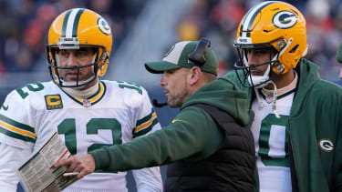 Green Bay Packers quarterback Aaron Rodgers (12) and quarterback Jordan Love (10) listen to head coach Matt LaFleur.