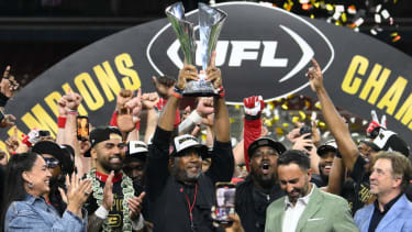 Jun 14, 2025; St. Louis, MO, USA;  DC Defenders head coach Shannon Harris raises the UFL Championship trophy after defeating the Michigan Panthers in the 2025 UFL Championship at The Dome at America’s Center. Mandatory Credit: Jeff Le-Imagn Images