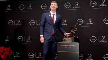 Dec 13, 2025; New York, NY, USA; Indiana Hoosiers quarterback Fernando Mendoza poses for photos with the Heisman trophy during a press conference at the New York Marriott Marquis after winning the award. Mandatory Credit: Brad Penner-Imagn Images