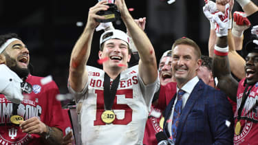 Dec 6, 2025; Indianapolis, IN, USA; Indiana Hoosiers quarterback Fernando Mendoza (15) celebrates with the MVP trophy after defeating the Ohio State Buckeyes in the 2025 Big Ten championship game at Lucas Oil Stadium. Mandatory Credit: Robert Goddin-Imagn Images