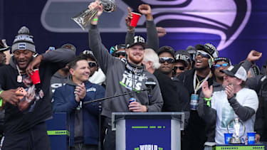 Seattle Seahawks quarterback Sam Darnold holds the Vince Lombardi trophy during the Super Bowl LX trophy celebration at Lumen Field.