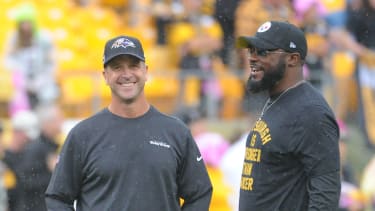 Oct 6, 2019; Pittsburgh, PA, USA; Baltimore Ravens head coach John Harbaugh (left) talks with Pittsburgh Steelers head coach Mike Tomlin before a game at Heinz Field. Mandatory Credit: Philip G. Pavely-Imagn Images