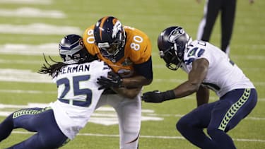 SEATTLE SEAHAWKS Julius Thomas (80) of the Denver Broncos is hit by Richard Sherman (25) and Kam Chancellor (31) of the Seattle Seahawks during the first half of Super Bowl XLVIII