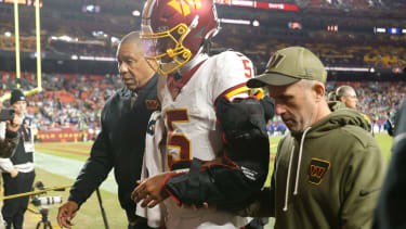 Nov 2, 2025; Landover, Maryland, USA; Washington Commanders quarterback Jayden Daniels (5) is helped off the field after an injury during the second half against the Seattle Seahawks at Northwest Stadium. Mandatory Credit: Amber Searls-Imagn Images