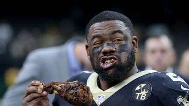 Nov 22, 2018; New Orleans, LA, USA; New Orleans Saints running back Mark Ingram (22) enjoys a turkey leg from NBC Sports after their game against the Atlanta Falcons on Thanksgiving at the Mercedes-Benz Superdome.  Mandatory Credit: Chuck Cook-Imagn Images