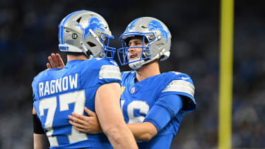 Nov 17, 2024; Detroit, Michigan, USA; Detroit Lions quarterback Jared Goff (16) greets center Frank Ragnow (77)