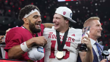 Dec 6, 2025; Indianapolis, IN, USA; Indiana Hoosiers quarterback Fernando Mendoza (15) celebrates with the MVP trophy and wide receiver Elijah Sarratt (13) after defeating the Ohio State Buckeyes in the 2025 Big Ten championship game at Lucas Oil Stadium. Mandatory Credit: Aaron Doster-Imagn Images