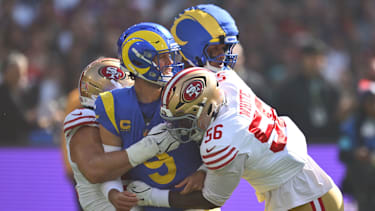 MELBOURNE, AUSTRALIA - SEPTEMBER 11: Matthew Stafford #9 of the Los Angeles Rams is tackled after making a pass in the first quarter of the NFL football game against the San Francisco 49ers at the Melbourne Cricket Ground on September 11, 2026 in Melbourne, Australia. (Photo by Quinn Rooney/Getty Images)
