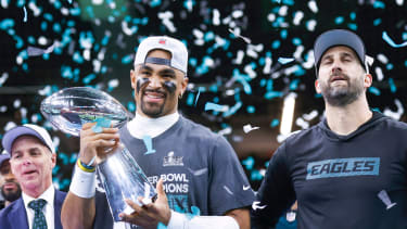 Jalen Hurts (1) holds the Vince Lombardi Trophy next to head coach Nick Sirianni