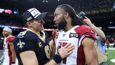 New Orleans, LA, USA; New Orleans Saints quarterback Drew Brees (9) talks to Arizona Cardinals wide receiver Larry Fitzgerald (11)