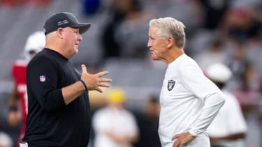 Aug 23, 2025; Glendale, Arizona, USA; Las Vegas Raiders offensive coordinator Chip Kelly (left) with head coach Pete Carroll against the Arizona Cardinals during a preseason NFL game at State Farm Stadium. Mandatory Credit: Mark J. Rebilas-Imagn Images
