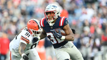 Oct 26, 2025; Foxborough, Massachusetts, USA;  New England Patriots running back Treveyon Henderson (32) runs with the ball against Cleveland Browns defensive end Alex Wright (91) during the fourth quarter at Gillette Stadium. Mandatory Credit: Brian Fluharty-Imagn Images