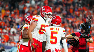 Nov 16, 2025; Denver, Colorado, USA; Kansas City Chiefs tight end Travis Kelce (87) celebrates his touchdown with wide receiver Marquise Brown (5) in the fourth quarter against the Denver Broncos at Empower Field at Mile High. Mandatory Credit: Ron Chenoy-Imagn Images