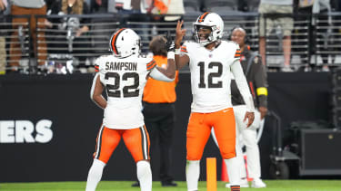 Cleveland Browns quarterback Shedeur Sanders (12) celebrates with running back Dylan Sampson (22)
