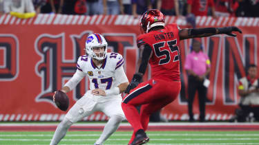 Buffalo Bills quarterback Josh Allen (17) runs with the ball as Houston Texans defensive end Danielle Hunter (55)