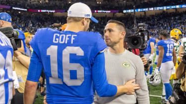 Nov 23, 2023; Detroit, Michigan, USA; Green Bay Packers Head Coach Matt LaFleur talks to Detroit Lions quarterback Jared Goff (16) after the annual Thanksgiving Day game at Ford Field. Mandatory Credit: David Reginek-Imagn Images
