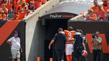 Sep 14, 2025; Cincinnati, Ohio, USA; Cincinnati Bengals quarterback Joe Burrow (9) is assisted to the locker room with an injury in the second quarter at Paycor Stadium. Mandatory Credit: Sam Greene-USA TODAY Network via Imagn Images