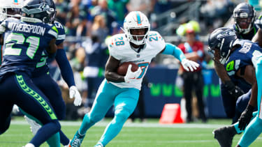 Sep 22, 2024; Seattle, Washington, USA; Miami Dolphins running back DeVon Achane (28) rushes against the Seattle Seahawks during the first quarter at Lumen Field. Mandatory Credit: Joe Nicholson-Imagn Images