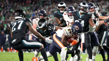 Nov 28, 2025; Philadelphia, Pennsylvania, USA; Chicago Bears running back Kyle Monangai (25) carries the ball for a touchdown defended by Philadelphia Eagles cornerback Quinyon Mitchell (27) and linebacker Nakobe Dean (17) during the fourth quarter of the game at Lincoln Financial Field. Mandatory Credit: Bill Streicher-Imagn Images