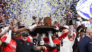 Dec 6, 2025; Atlanta, GA, USA; The Georgia Bulldogs lifts the SEC Championship trophy after the game against the Alabama Crimson Tide during the 2025 SEC Championship game at Mercedes-Benz Stadium. Mandatory Credit: Brett Davis-Imagn Images