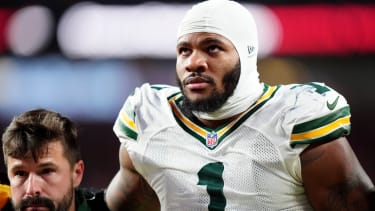 Dec 14, 2025; Denver, Colorado, USA; Green Bay Packers defensive end Micah Parsons (1) walks off the field with help from medical personnel following an injury during the third quarter against the Denver Broncos at Empower Field at Mile High. Mandatory Credit: Ron Chenoy-Imagn Images