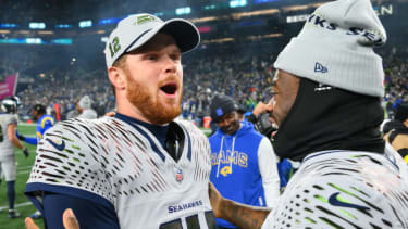Dec 18, 2025; Seattle, Washington, USA; Seattle Seahawks quarterback Sam Darnold (14) and quarterback Jalen Milroe (6) celebrate after defeating the Los Angeles Rams in overtime at Lumen Field. Mandatory Credit: Steven Bisig-Imagn Images