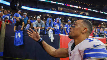 Nov 10, 2024; Houston, Texas, USA; Detroit Lions wide receiver Amon-Ra St. Brown (14) throws a piece of his equipment to the fans as he runs off the field after the Lions defeated the Houston Texans at NRG Stadium. Mandatory Credit: Thomas B. Shea-Imagn Images